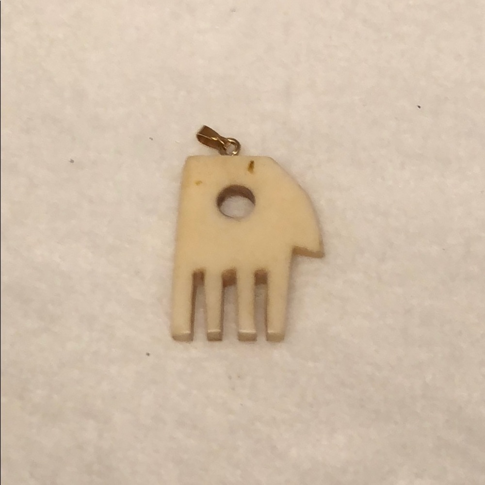 Carved fossilized ivory “hand” pendant